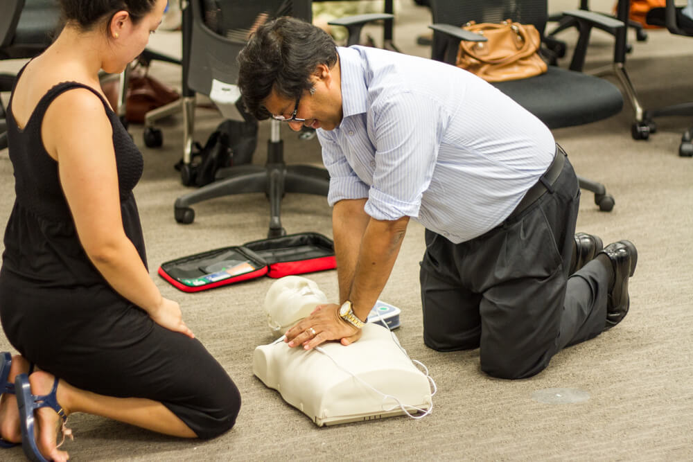 Engaging First Aid Training Session: Performing CPR on Mannequins with Primary Healthcare South Staff